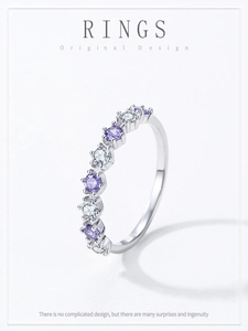 Macro detail of S925 silver ring featuring alternating purple and white gemstones