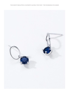 Detail of S925 silver stud earrings with blue round zircon in classic 4-prong setting
