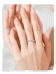Detail of S925 silver ring featuring alternating purple and white zircon stones on hand