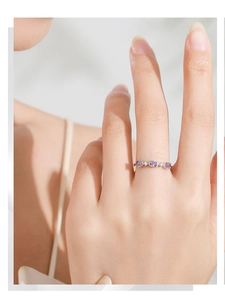 Detailed macro of S925 sterling silver ring with three oval purple gemstones on hand
