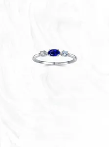 Macro shot of S925 sterling silver ring with oval blue sapphire and side stones