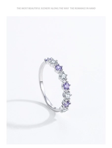 Macro shot of S925 silver ring featuring purple and white round-cut pavé zircons