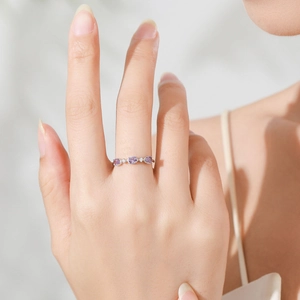 Elegant S925 sterling silver ring featuring purple and white zircon stones on a model hand