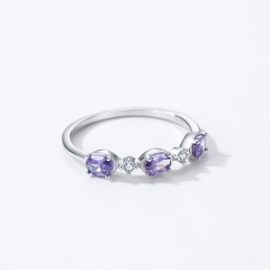 S925 sterling silver ring with purple oval zircons and white stones on grey background