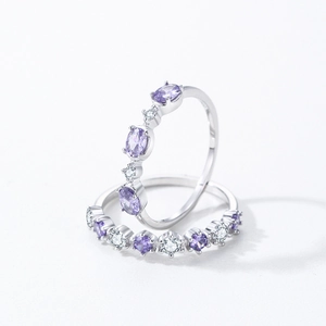 S925 sterling silver ring set with purple and white cubic zirconia on a white background