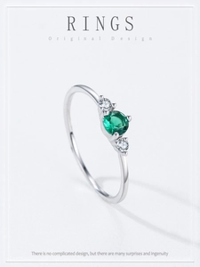 Macro view of round emerald cut gemstone ring with side diamonds on S925 silver