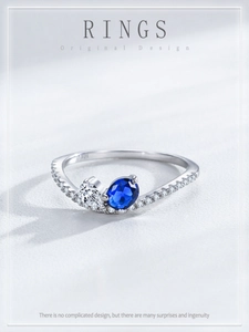 Detail of S925 silver ring featuring blue oval sapphire and heart-shaped zircon stones