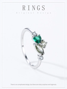 Macro view of heart-shaped emerald stone on a vintage 925 sterling silver ring