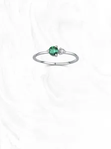Detailed close-up of S925 sterling silver ring with emerald zircon and bypass design