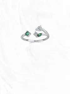 Macro shot of S925 sterling silver branch ring with green gems and zircons
