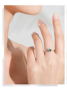 Close-up of vintage 925 silver ring with green emerald-cut zircon on a model finger