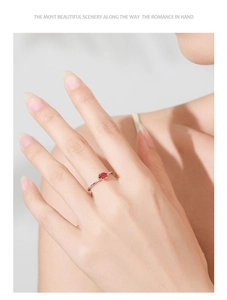 Detailed view of an elegant 925 silver ring featuring an oval red zircon center stone