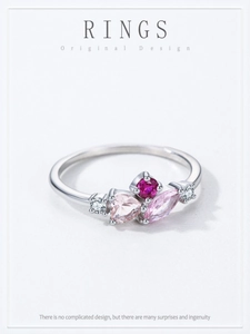 Detail of silver ring featuring pink stones and a marquise-cut center gem in a cluster design