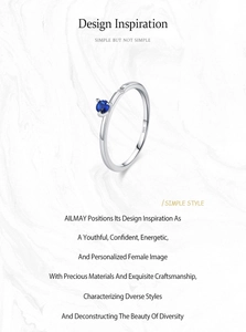 Macro shot of S925 sterling silver ring featuring blue sapphire and engraved hallmark