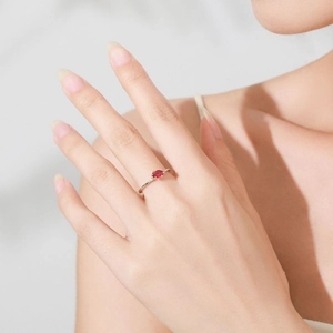 Elegant 925 sterling silver ring with oval ruby gemstone and side diamonds on female finger