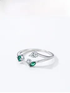 Detail of silver branch ring with sparkling green and clear teardrop gemstones