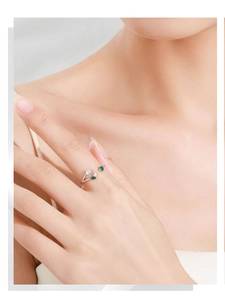 Detailed view of leaf-shaped S925 silver ring with green and white gemstones