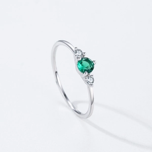 Classic S925 silver ring featuring a round green gemstone and side stones on white background