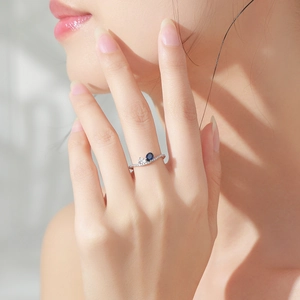 Elegant 925 sterling silver ring featuring an oval sapphire and wavy zircon band