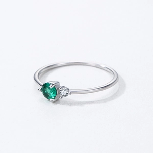 Minimalist 925 sterling silver ring featuring a round green emerald zircon and small side stone