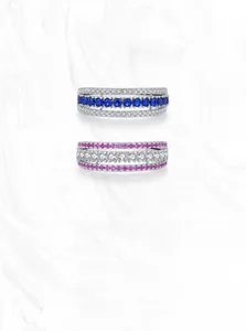 Detailed macro view of S925 silver layered rings with blue sapphires and pink zircons