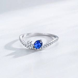 Elegant 925 sterling silver ring featuring blue sapphire and round white zircon gemstones