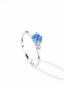 Close-up of S925 silver ring featuring a round blue gemstone and small clear zircon