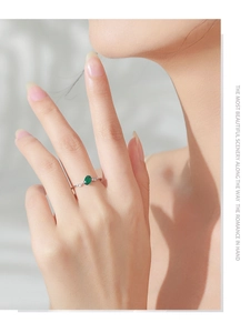 Detailed view of an S925 silver ring featuring an oval green gemstone and white zircon
