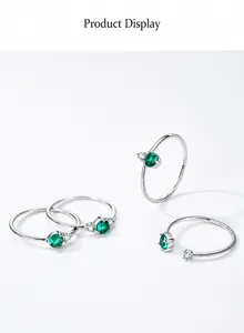 Macro shot of S925 sterling silver stamp and emerald green stone detail on rings