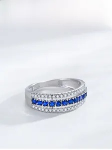 Macro detail of S925 sterling silver ring featuring blue sapphire pavé and micro-diamonds