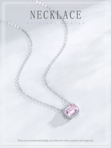 Macro detail of square pink crystal pendant with sparkling zircon halo on silver chain