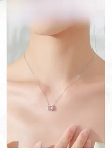 Detail of S925 silver necklace with pink rectangular gemstone and diamond halo on neck