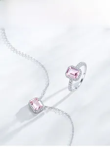 Detail of S925 silver necklace and ring set featuring rectangular pink gemstone accents