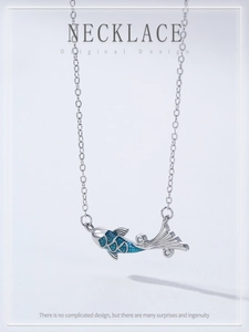 Detailed close-up of 925 sterling silver koi necklace with blue enamel and zircon stones