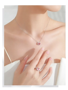 Close-up of S925 silver necklace and ring set with pink square zirconia gemstones
