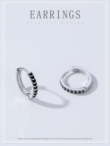 Close-up of 925 sterling silver hoop earrings with black enamel chevron arrow patterns