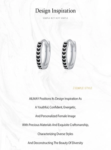 Close-up of S925 sterling silver hoop earrings with black enamel chevron pattern