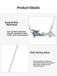Detail of 925 sterling silver koi fish pendant with blue enamel scales and zircon accents