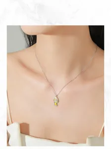 Detailed view of sterling silver clownfish necklace with enamel and cubic zirconia on model