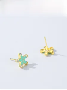 Detailed macro view of 925 sterling silver starfish earrings with blue enamel and zircon
