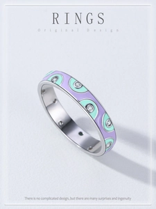 Detailed view of handmade 925 silver ring with purple and green enamel inlay and small zircons