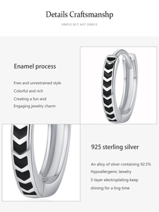 Detail view of 925 sterling silver hoop earrings with black enamel arrow patterns
