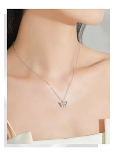 Detail of 925 sterling silver necklace with colorful butterfly pendant on model neck