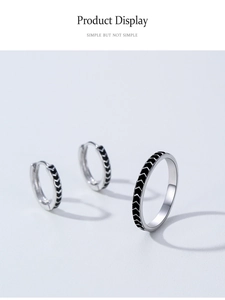 Detail view of 925 sterling silver hoop earrings and ring set with black arrow pattern