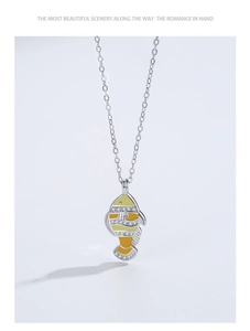 Detail of 925 sterling silver clownfish pendant with enamel and zircon inlay