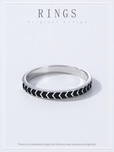 Macro shot of S925 silver ring featuring vintage black chevron patterns and arrow texture