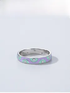 Detail showing 925 sterling silver ring with purple and green enamel and zircon stones