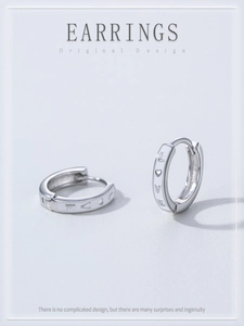 Detailed close-up of S925 sterling silver hoop earrings with LOVE and heart engravings