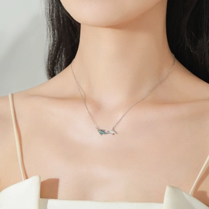 Elegant 925 sterling silver koi fish pendant necklace with blue stones on female model