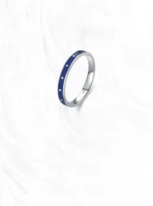 Detail of S925 silver ring with blue enamel and white dots with internal S925 hallmark